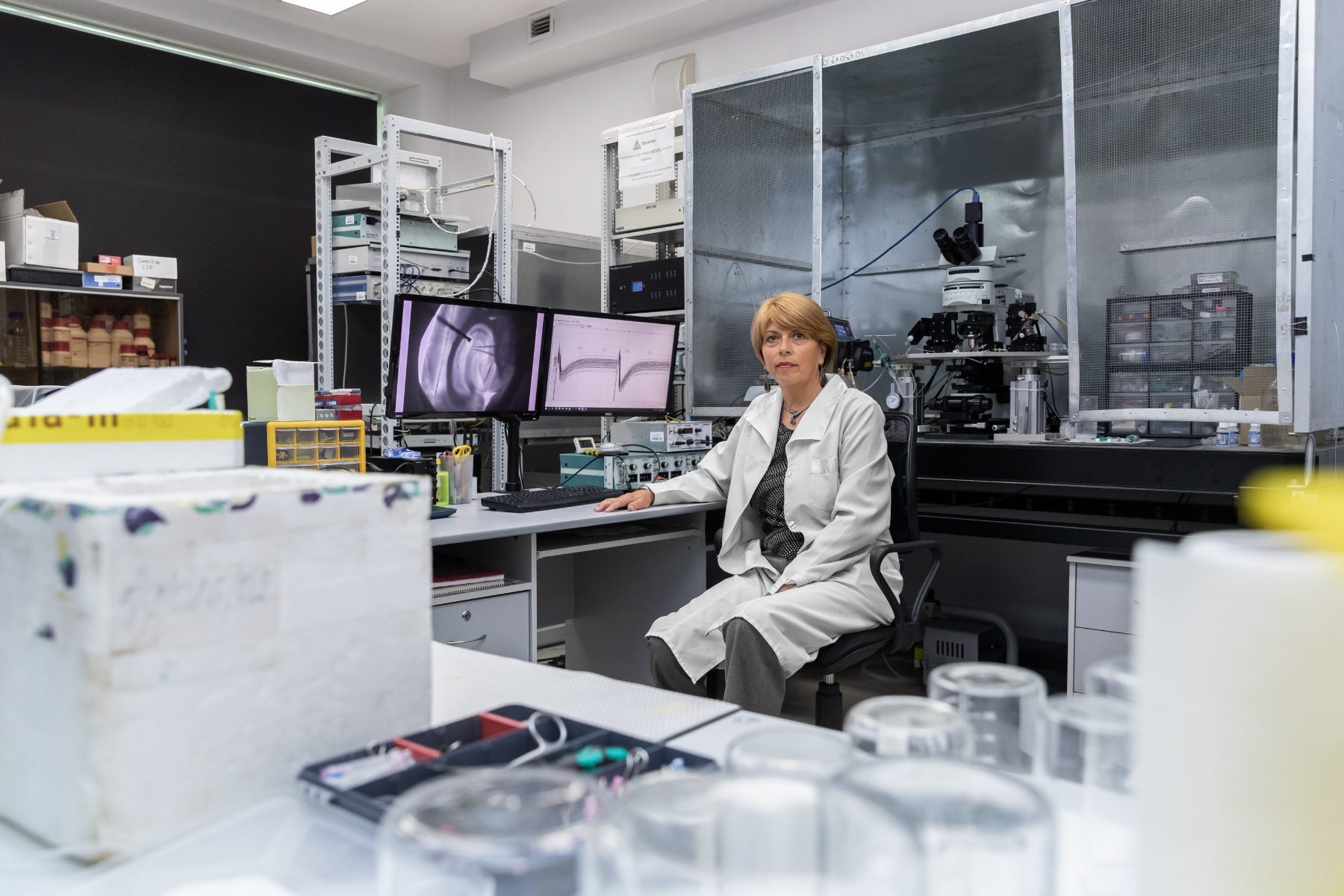 Fourteen members of a research group standing together in their laboratory